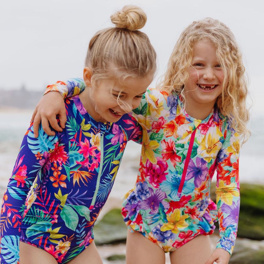 girls hugging on beach wearing ocean tales swimwear