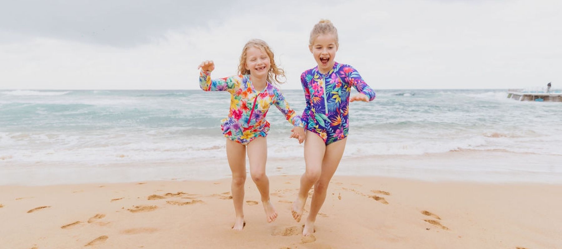 girls running on beach in Ocean Tales swimwear